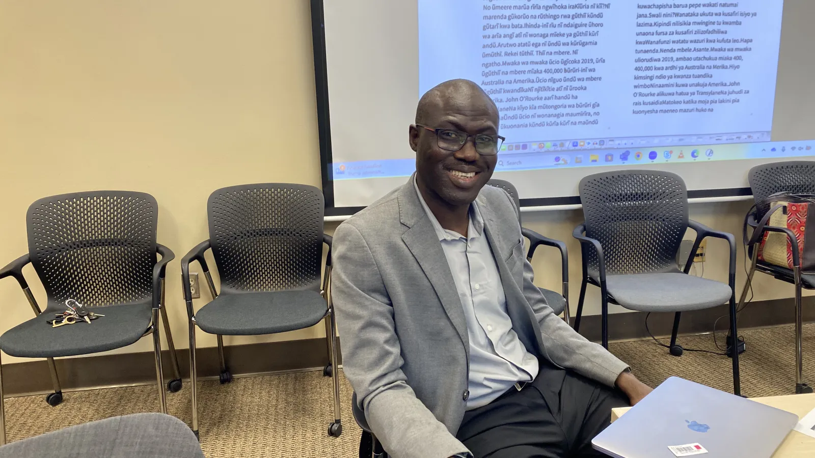 A member of the Association for African Studies Programs smiling fro the camera.