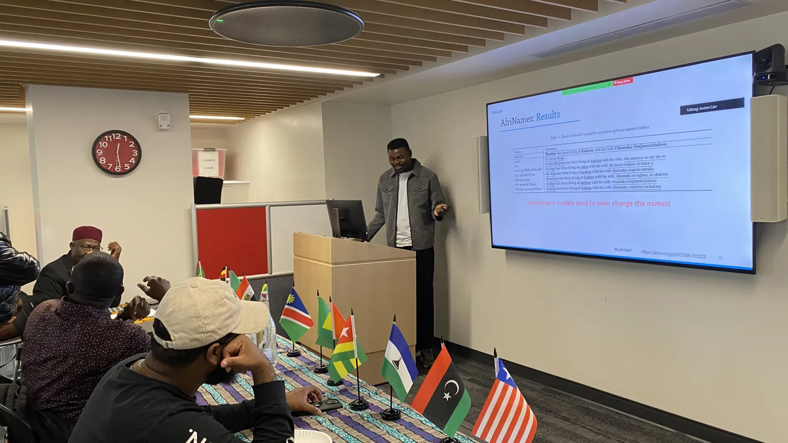 Picture of Abraham Toluwase Owodunni lecturing at Africa at Noon with attendees.