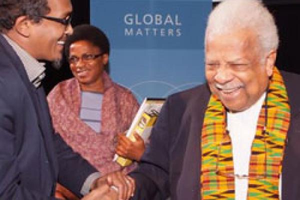 Professor Ali Mazrui shaking hands with participants.