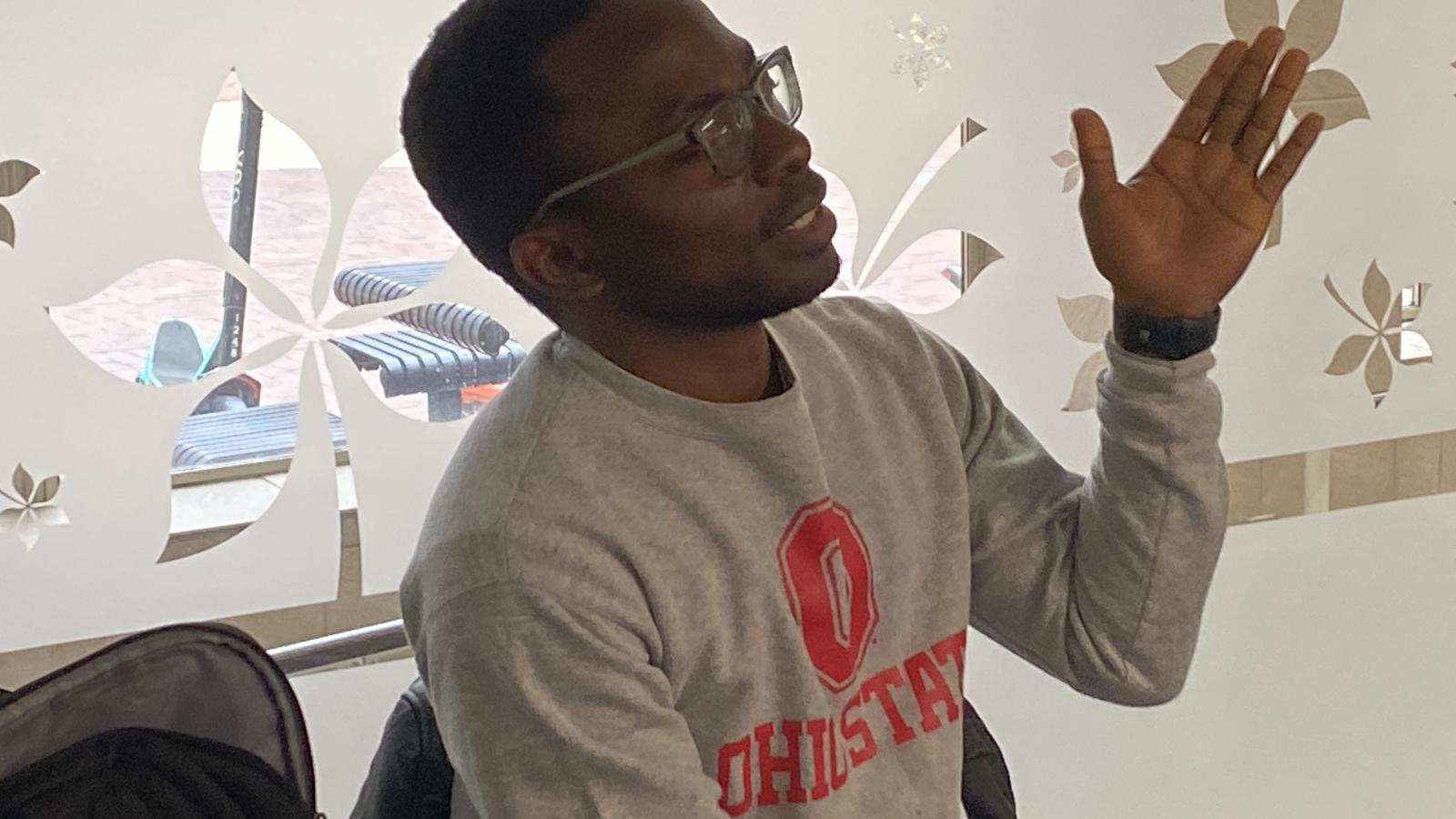 Attendee asking a question at Africa at Noon lecture.