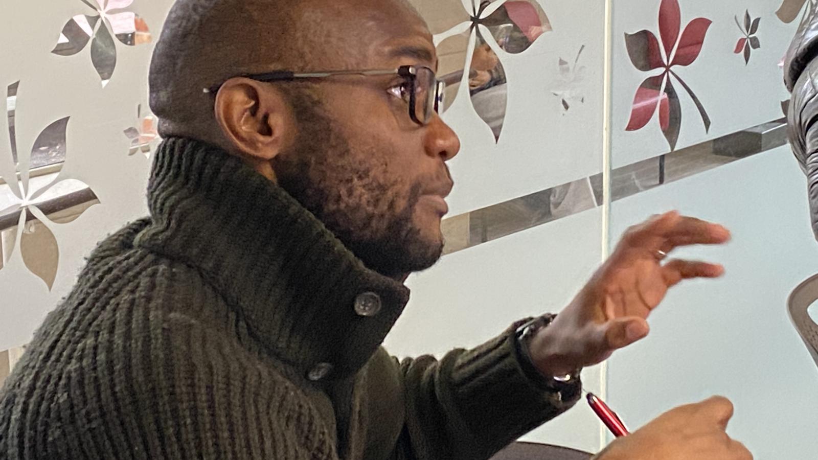 Attendee asking a question at Africa at Noon lecture.