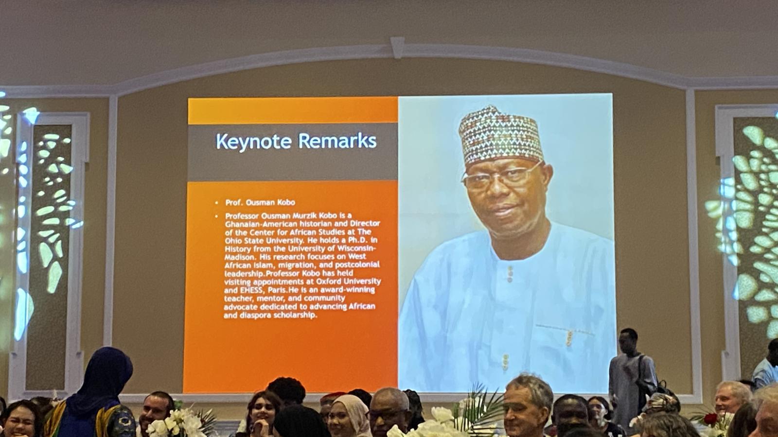 Dr. Kobo's biography on screen at Ohio University's Africa Night Celebration